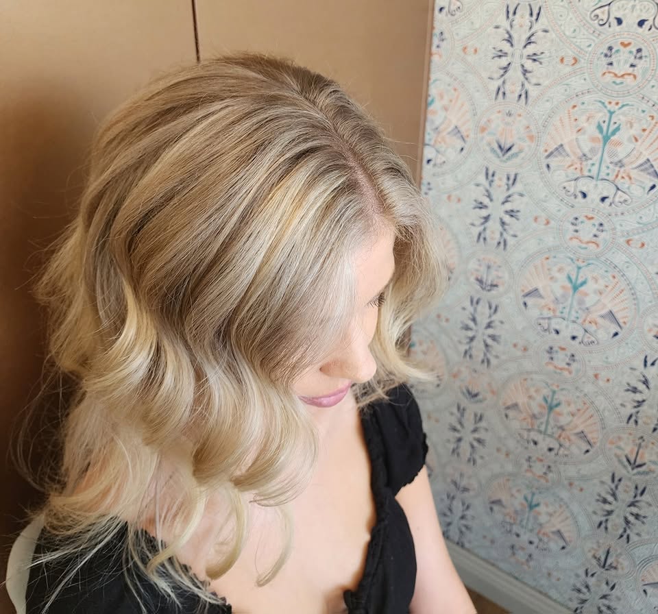 Soft blonde waves styled to the side